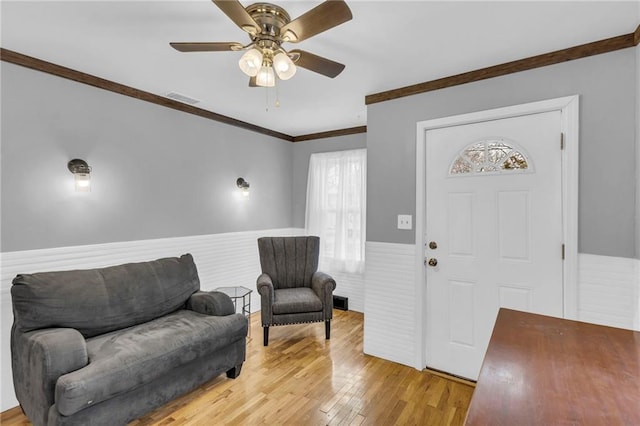 foyer featuring ceiling fan, light hardwood / wood-style flooring, and ornamental molding