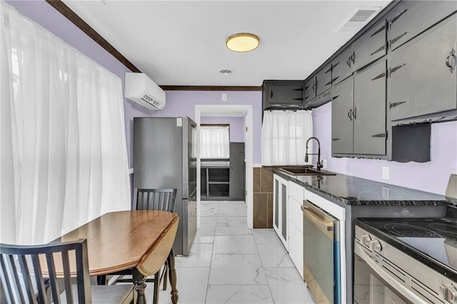 kitchen featuring sink, a wall mounted AC, dark stone countertops, appliances with stainless steel finishes, and ornamental molding