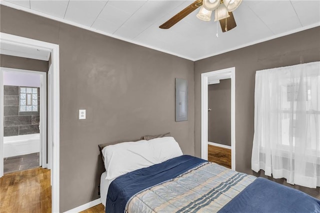 bedroom with electric panel, ceiling fan, and hardwood / wood-style flooring