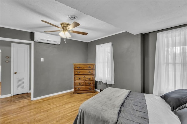 bedroom with multiple windows, wood-type flooring, an AC wall unit, and ceiling fan