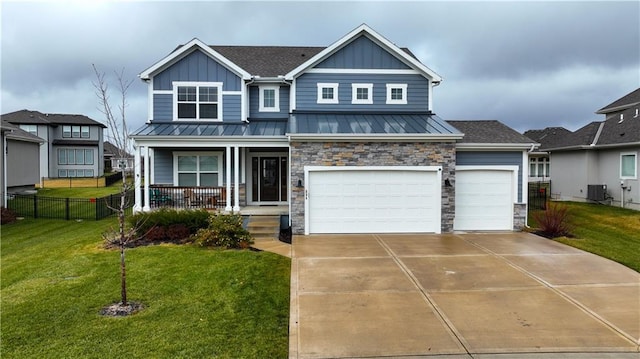 view of front of home featuring cooling unit, a front lawn, a porch, and a garage