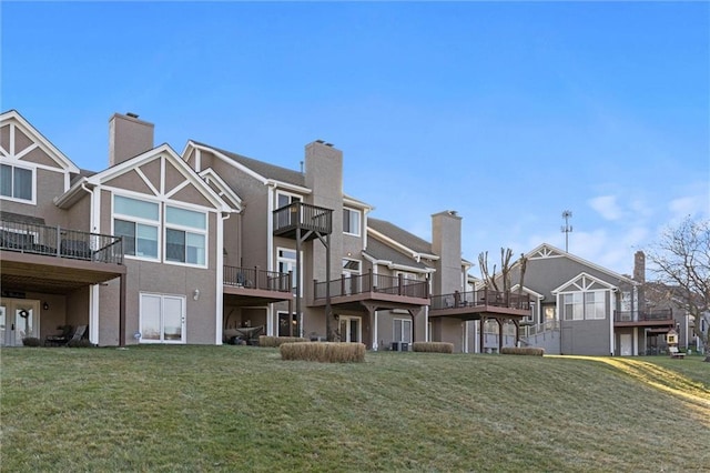 rear view of house featuring a lawn