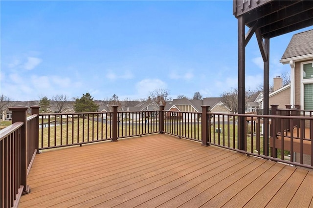 wooden deck featuring a lawn