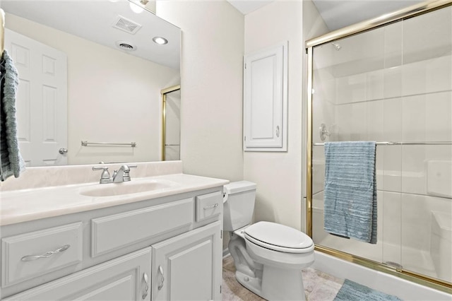 bathroom with vanity, toilet, and a shower with shower door