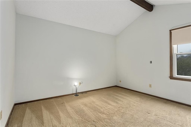 unfurnished room with lofted ceiling with beams and carpet flooring