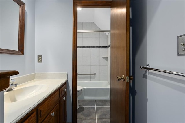 full bathroom with tile patterned flooring, vanity, tiled shower / bath, and toilet