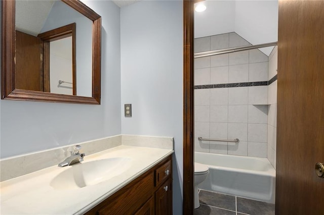 full bathroom with vanity, tiled shower / bath combo, tile patterned floors, and toilet