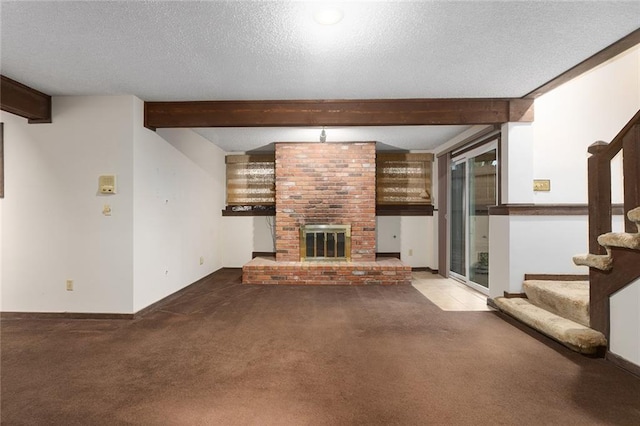 unfurnished living room featuring beamed ceiling, a fireplace, carpet floors, and a textured ceiling