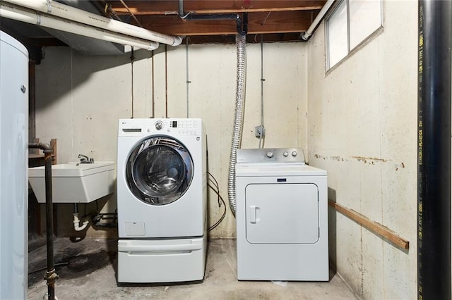 clothes washing area featuring sink and washing machine and dryer