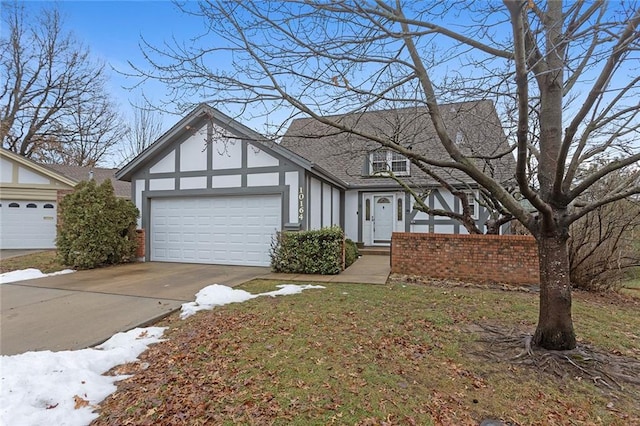 english style home featuring a garage