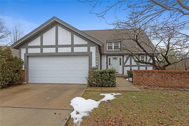 tudor house featuring a garage