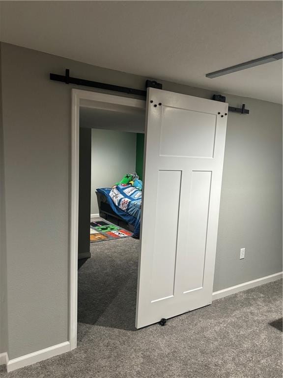 carpeted bedroom with a barn door