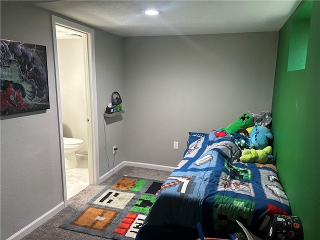 carpeted bedroom featuring ensuite bath