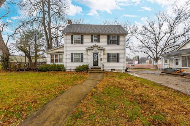 colonial-style house with a front yard