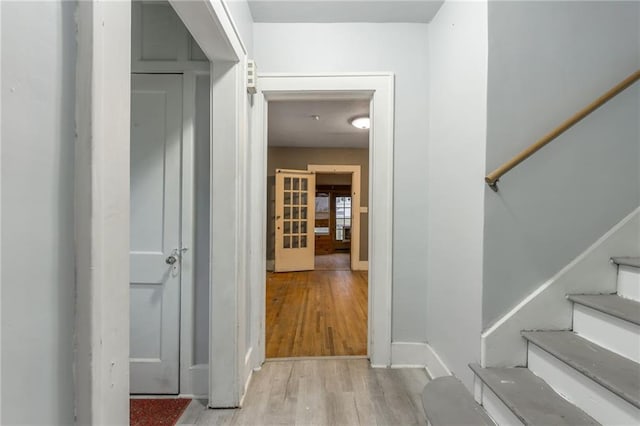 corridor with light hardwood / wood-style flooring