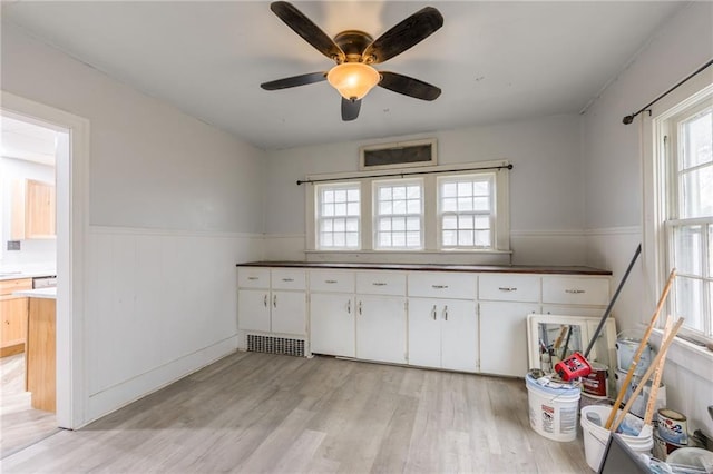 kitchen featuring white cabinets, ceiling fan, and light wood-type flooring