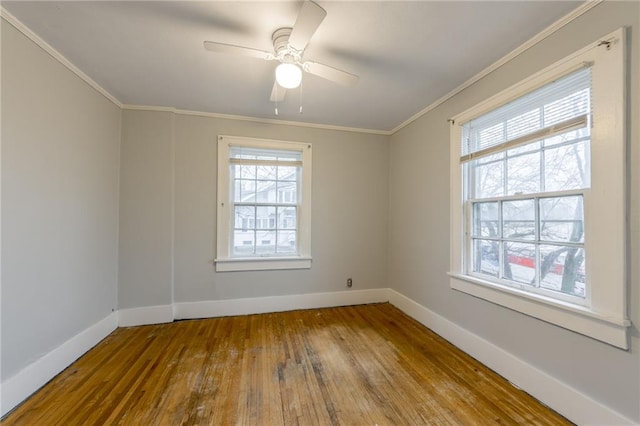 spare room featuring ceiling fan, wood-type flooring, and crown molding