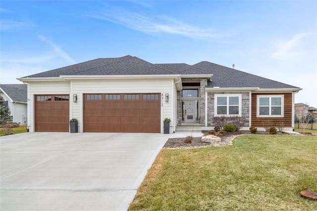 prairie-style home featuring a garage and a front yard