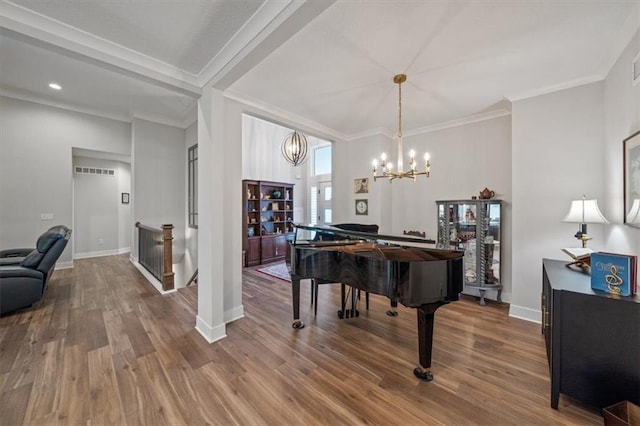 miscellaneous room featuring a notable chandelier, hardwood / wood-style flooring, and ornamental molding