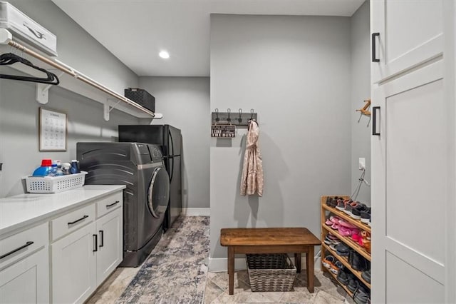 laundry area featuring cabinets and separate washer and dryer