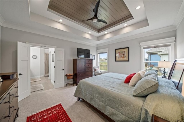 bedroom with crown molding, ceiling fan, a tray ceiling, and light carpet