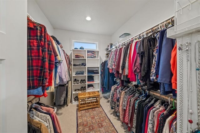 walk in closet with carpet flooring