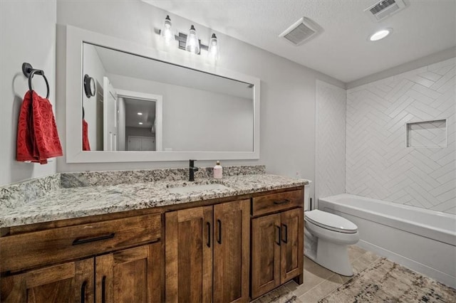 full bathroom featuring tiled shower / bath combo, vanity, and toilet