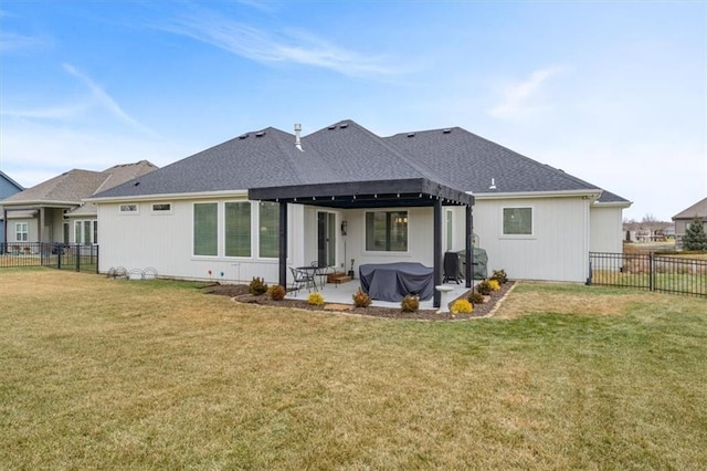 back of house featuring a patio and a lawn