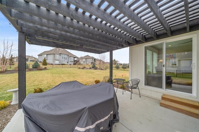 view of patio with area for grilling and a pergola