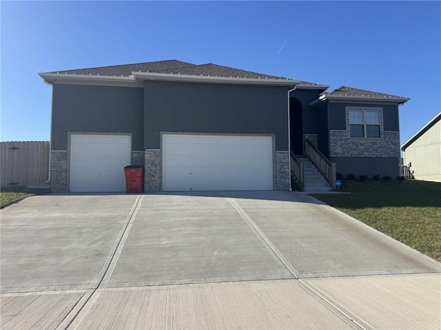 view of front of house featuring a garage and a front lawn