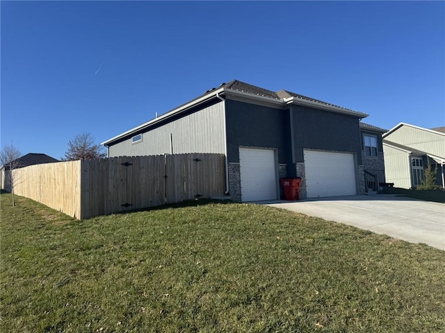 view of side of property with a garage and a lawn