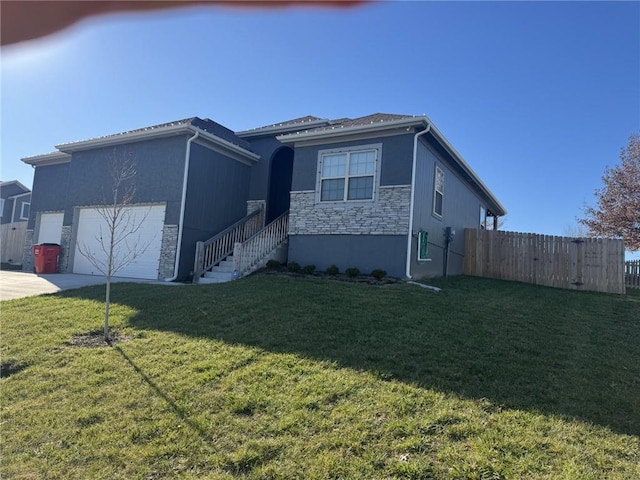 view of side of property featuring a yard and a garage