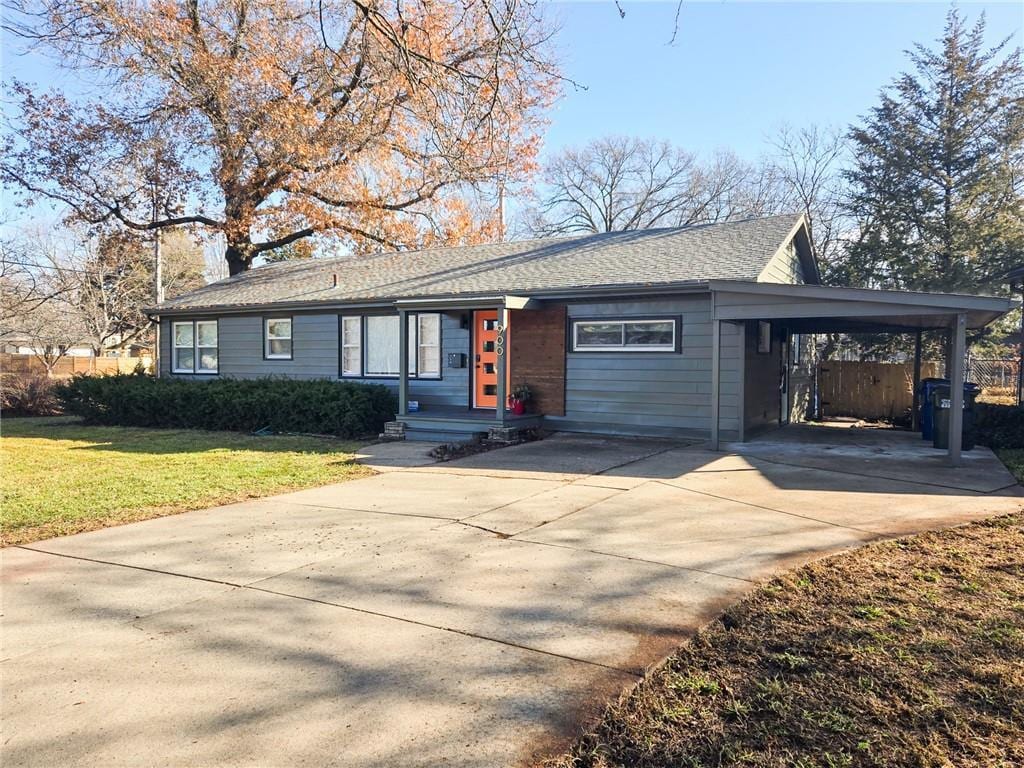 ranch-style home with a front lawn and a carport