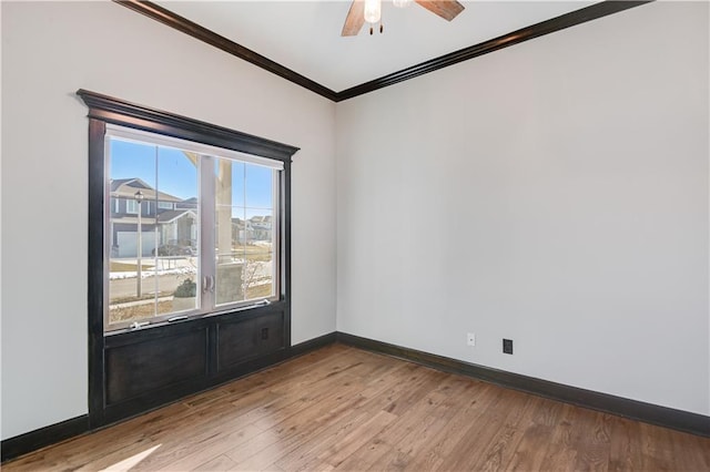 empty room with crown molding, ceiling fan, and light hardwood / wood-style floors