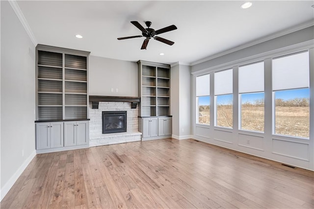 unfurnished living room with crown molding, ceiling fan, and light wood-type flooring