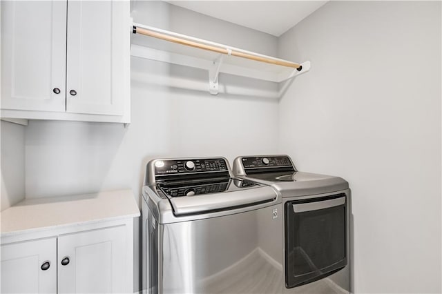 washroom with cabinets and independent washer and dryer