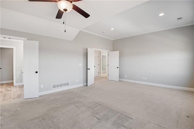 unfurnished bedroom with light carpet, vaulted ceiling, ornamental molding, and ceiling fan