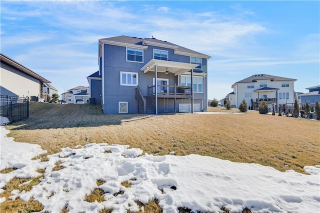 snow covered house featuring a lawn