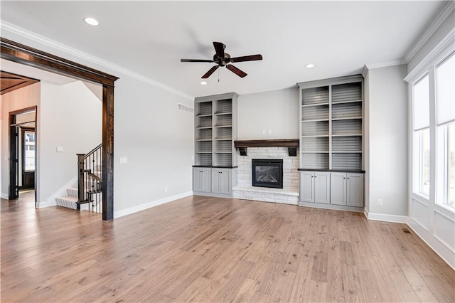 unfurnished living room featuring crown molding, ceiling fan, and light hardwood / wood-style flooring