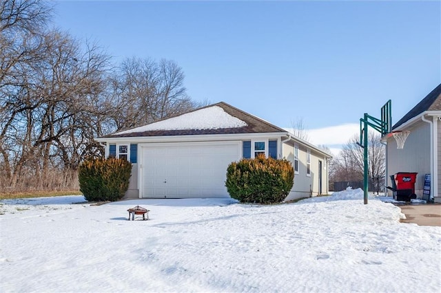 view of snowy exterior with a garage