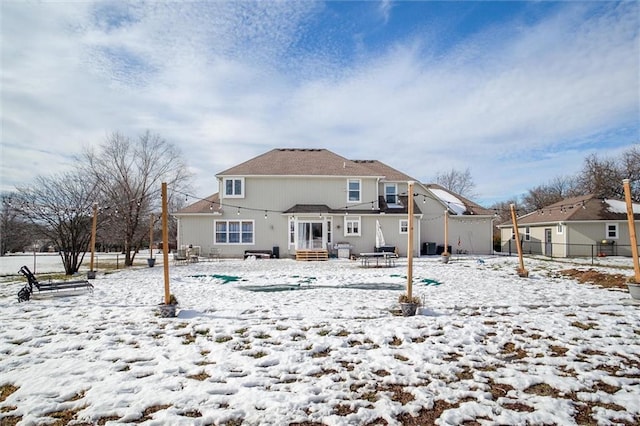 view of snow covered back of property