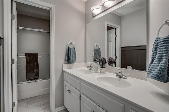 bathroom with shower / bath combination with glass door and vanity