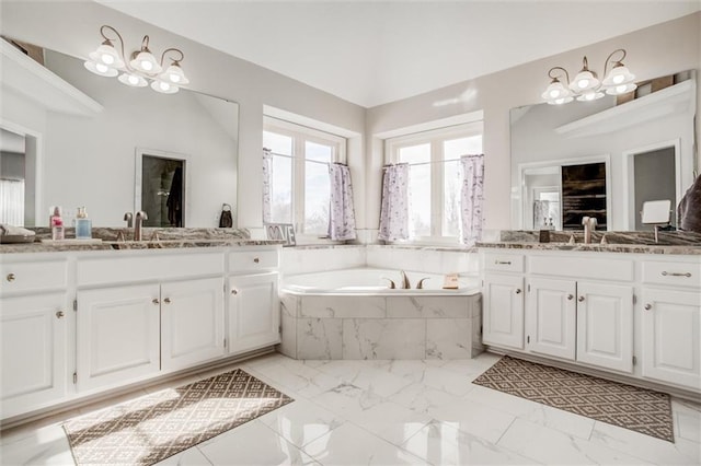 bathroom with a relaxing tiled tub and vanity