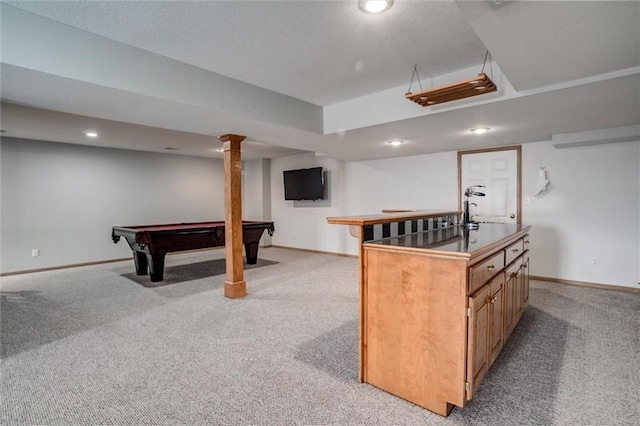 interior space with light colored carpet, billiards, and an island with sink