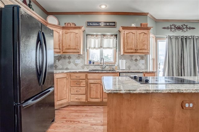 kitchen with black appliances, backsplash, ornamental molding, and sink