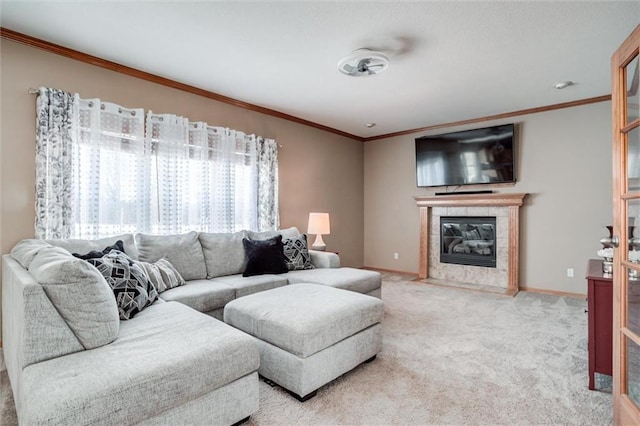 living room with a tile fireplace, ornamental molding, and carpet flooring