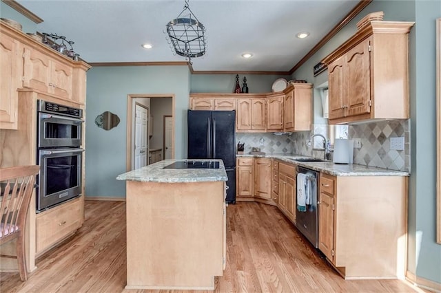 kitchen featuring light brown cabinetry, appliances with stainless steel finishes, hanging light fixtures, sink, and a kitchen island