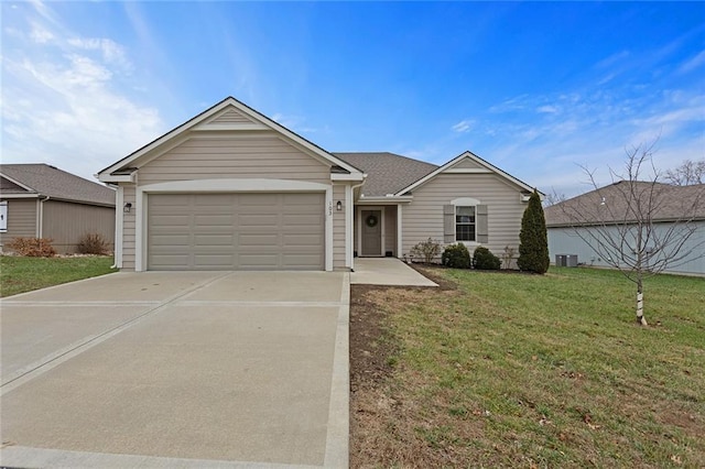 ranch-style home featuring an attached garage, roof with shingles, concrete driveway, and a front yard