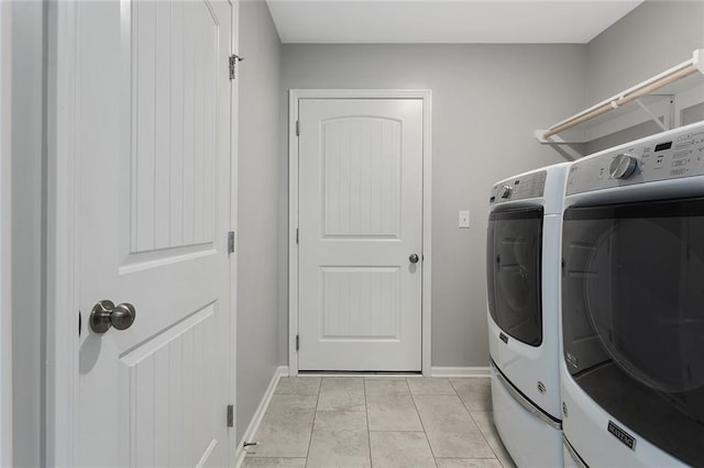 laundry room featuring light tile patterned flooring and separate washer and dryer