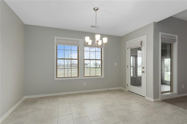 unfurnished dining area with an inviting chandelier